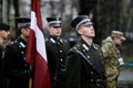 Latvian soldiers in ceremonial uniforms take part at the Romanian National Day military parade during a snowy day