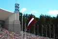 The Latvian Song and Dance Festival in Riga, Latvia. Latvian flag. The raising of the Latvian flag