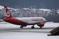 Lauda Airline plane taxiing on a snowy runway, Innsbruck Airport INN