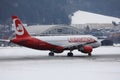 Lauda Airline plane taxiing on a snowy runway, Innsbruck Airport INN