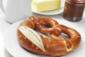 A laugenbrezel, a german pretzel, on a set table for breakfast Royalty Free Stock Photo