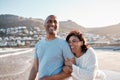 Laugh as loud as you love. A joyful couple, telling hilarious and funny jokes while walking on the beach on a romantic