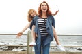 Laugh out loud. a mother giving her daughter a piggyback ride. Royalty Free Stock Photo