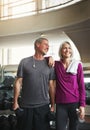 We laugh together and get fit together. a senior married couple smiling and taking a break from their workout at the gym Royalty Free Stock Photo
