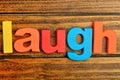 Laugh word on table
