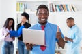 Laughing african american businessman at computer with group of black business people