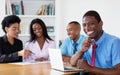 Laughing african american businessman with team and computer Royalty Free Stock Photo