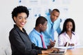 Laughing african american businesswoman at work at office