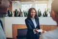 Laughing African American concierge talking with guests during c Royalty Free Stock Photo