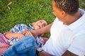 Laughing African American Father and Mixed Race Son Picnicking At The Park Royalty Free Stock Photo