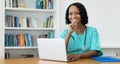 Laughing african american female doctor answering questions of patient online Royalty Free Stock Photo