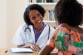 Laughing african american female doctor with patient Royalty Free Stock Photo
