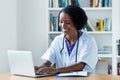 Laughing african american female medical scientist researching for vaccines against coronavirus