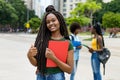 Laughing african american female student with amazing hairstyle Royalty Free Stock Photo