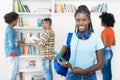 Laughing african american female student with dreadlocks and group of young adults