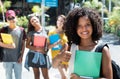 Laughing african american female student showing thumb with group of international students Royalty Free Stock Photo