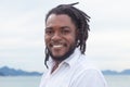 Laughing african american guy with dreadlocks and white shirt Royalty Free Stock Photo