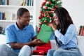 Laughing african american love couple with gifts and christmas presents Royalty Free Stock Photo