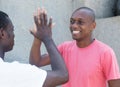 Laughing african american man giving high five