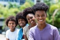 Laughing african american man with group of young adults in line Royalty Free Stock Photo