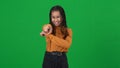 Laughing African American teen girl grimacing gesturing on green screen mocking. Portrait of adolescent bully sneering