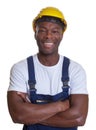 Laughing african construction worker with crossed arms