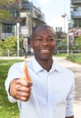 Laughing african man outside showing thumb up Royalty Free Stock Photo