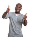 Laughing african man showing both thumbs Royalty Free Stock Photo