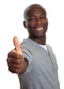 Laughing african man showing his right thumb Royalty Free Stock Photo