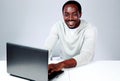 Laughing african man sitting at the table Royalty Free Stock Photo