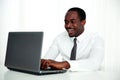 Laughing african man using laptop Royalty Free Stock Photo