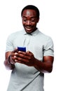 Laughing african man using smartphone Royalty Free Stock Photo