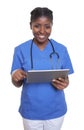 Laughing african nurse working with tablet computer Royalty Free Stock Photo