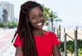 Laughing african woman with dreadlocks in the city Royalty Free Stock Photo