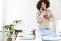 Laughing african woman wearing in casual clothes talking by smartphone