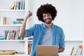 Laughing afro american hipster man in quarantine at computer Royalty Free Stock Photo