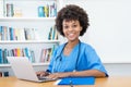 Laughing afro american nurse or medical student at computer Royalty Free Stock Photo