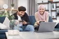 Laughing 30-aged funny Muslim couple having fun together while playing video games at home using gamepads. Family Royalty Free Stock Photo