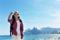 Laughing american hipster tourist at Ipanema beach at Rio de Janeiro