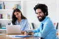 Laughing arabic businessman with female colleague