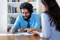 Laughing arabic businessman signing contract after job interview Royalty Free Stock Photo