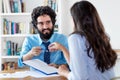 Laughing arabic businessman signing contract with trainee after job interview Royalty Free Stock Photo