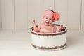 Laughing Baby Girl in Wooden Bucket