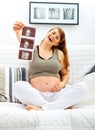 Laughing beautiful pregnant female with echo Royalty Free Stock Photo