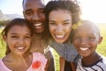 Laughing black family outdoors, close up, back lit portrait Royalty Free Stock Photo