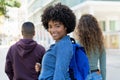 Laughing black female student with backpack and friends Royalty Free Stock Photo