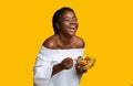 Laughing Black Woman Eating Healthy Vegetable Salad, Standing Over Yellow Background Royalty Free Stock Photo