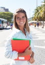 Laughing blonde student in the city