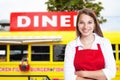 Laughing blonde waitress with food truck