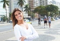 Laughing blonde woman with crossed arms in the city Royalty Free Stock Photo